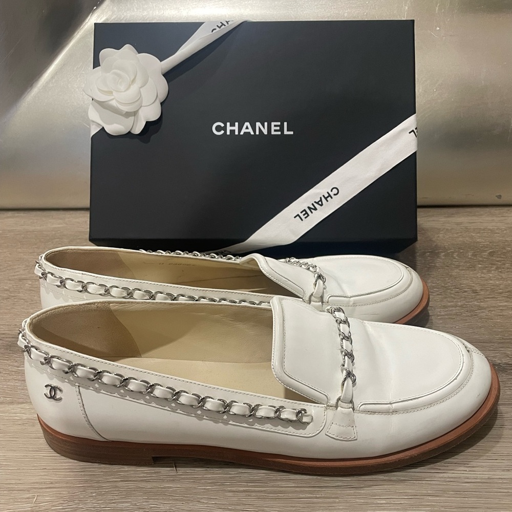 White patent leather Chanel loafers with chrome chain hardware